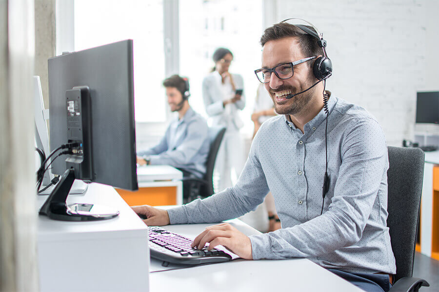 A team of tech support staff, assisting clients over the phone.